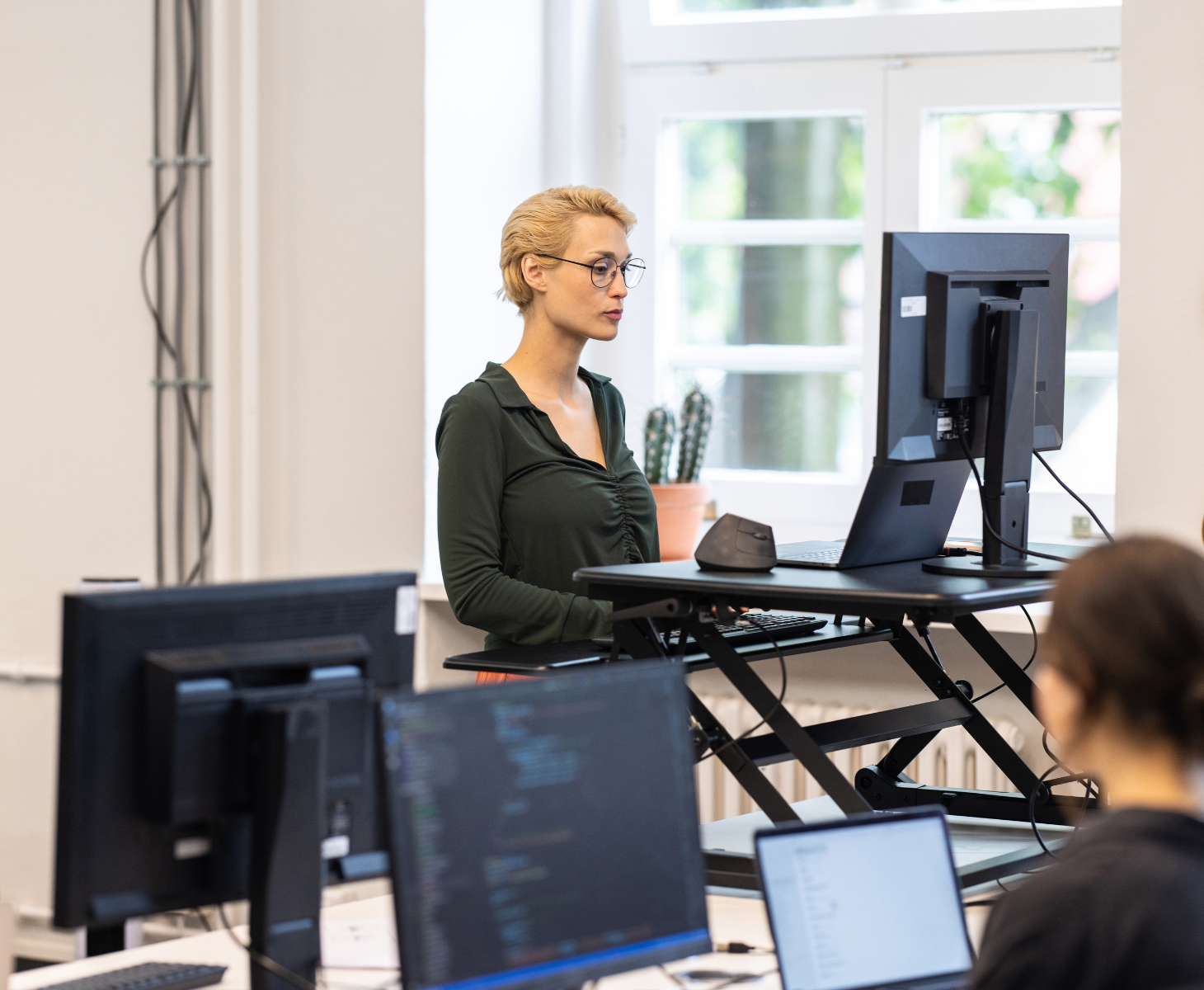 Young woman working at ergonomic standing desk