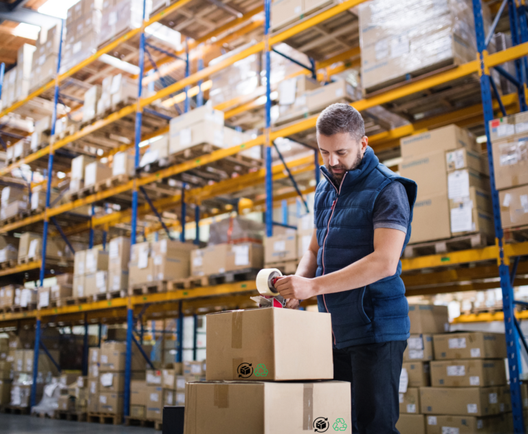 Male Warehouse Worker Sealing Cardboard Boxes