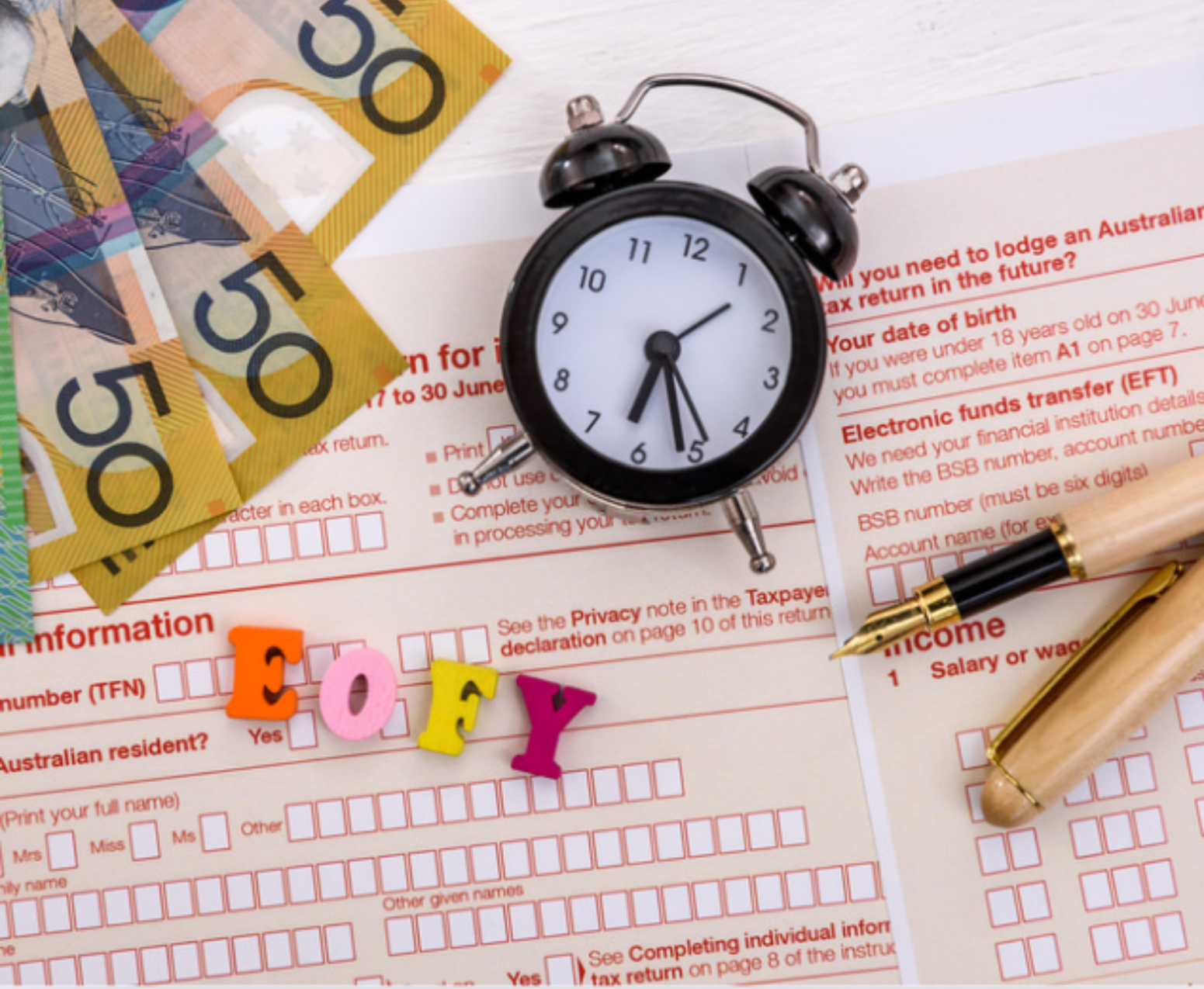 Clock with letters 'EOFY' on Australian tax form