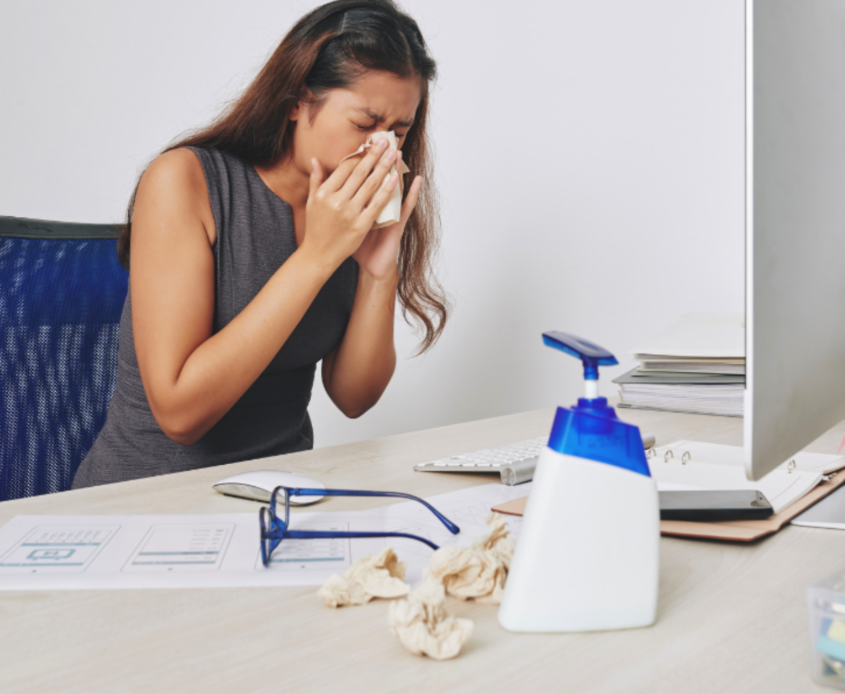 Employee in the Office Sneezing on a Tissue