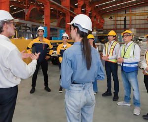 Workers wearing hard hats in a warehouse