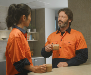 2 workers in office enjoying coffee break