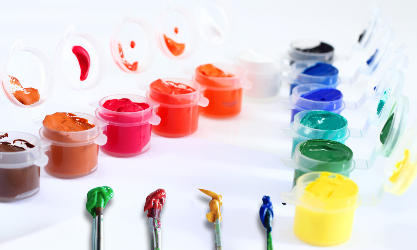 Paint on a white table and paint brushes